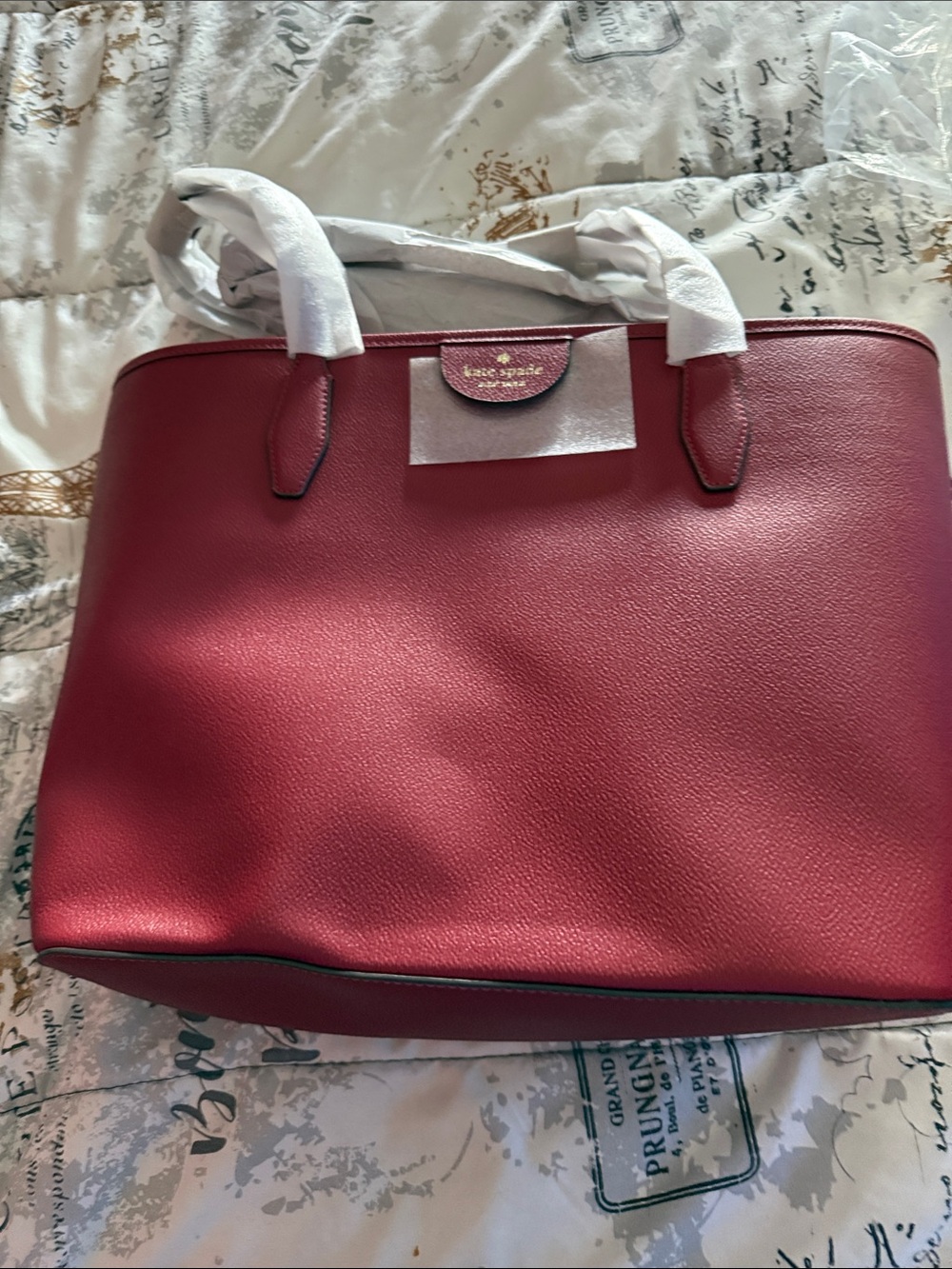 kate spade red tote with gold logo plaque